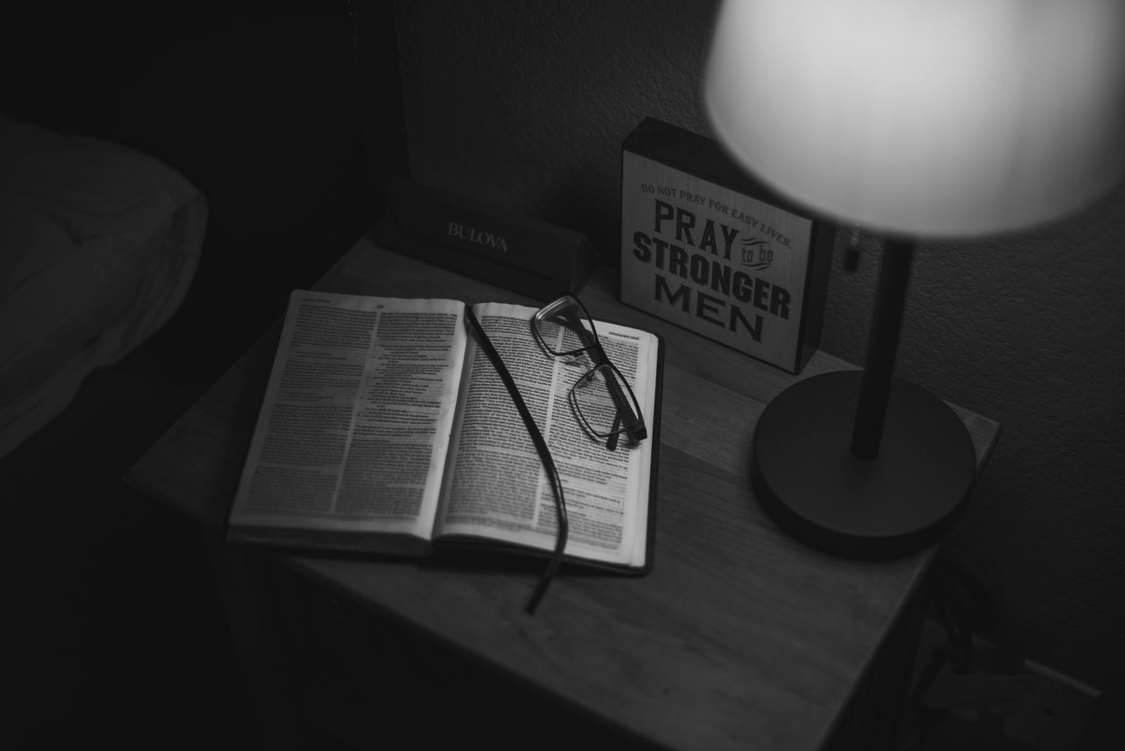 Nightstand with a book and glasses, a routine and discipline setting