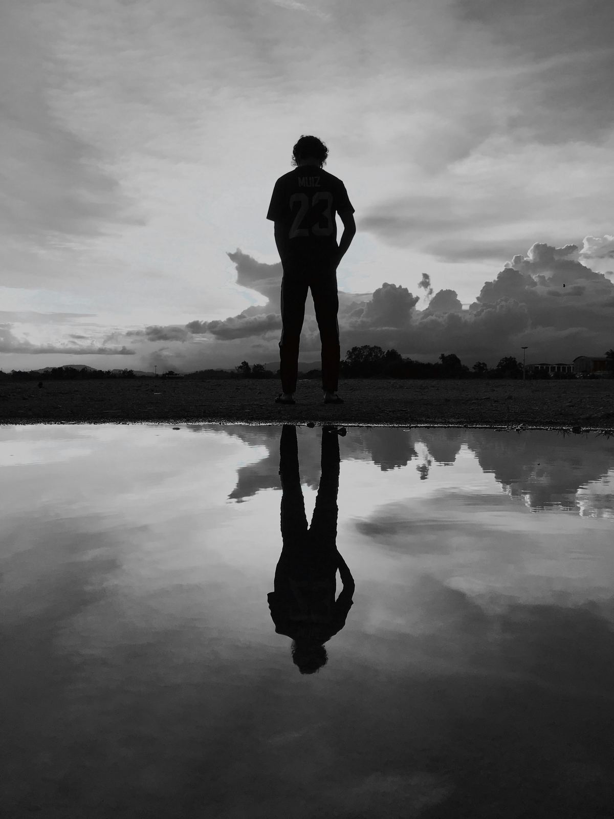 Silhouette of a person alone looking at the horizon
